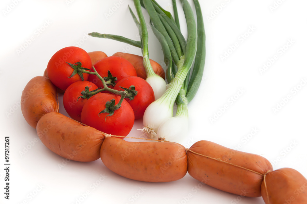 Fresh raw vegetables and sausage on a white background Fresh raw vegetables and sausage on a white background