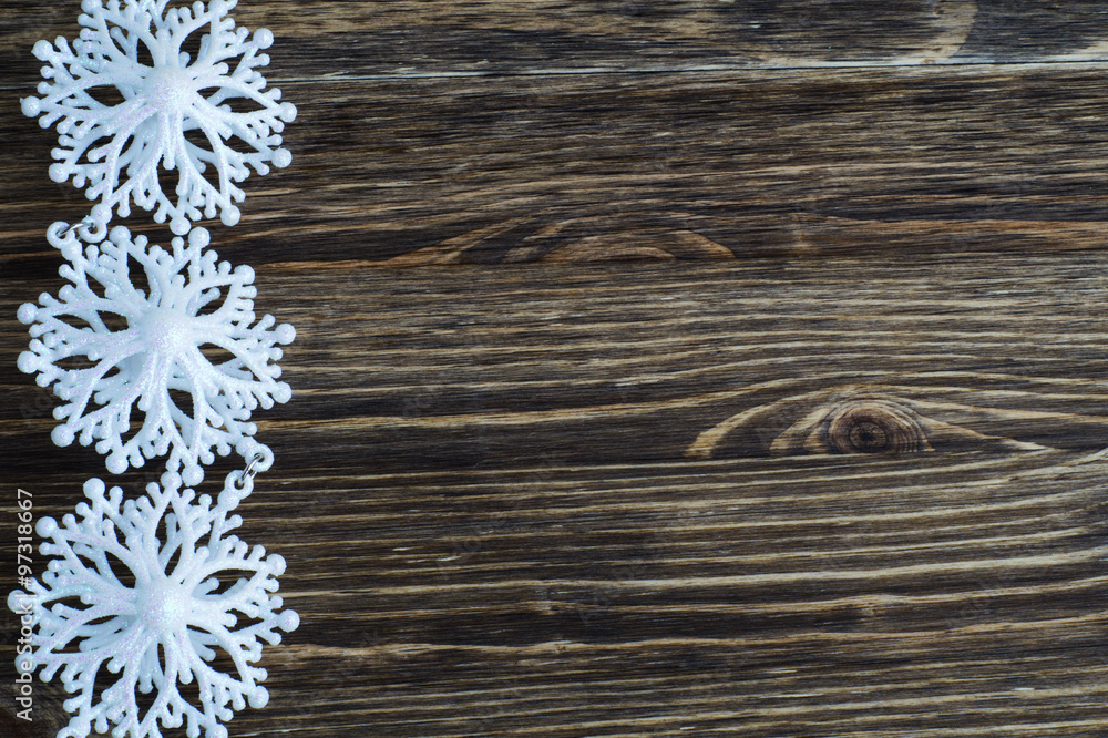 Fototapeta premium Snowflakes border on wooden background