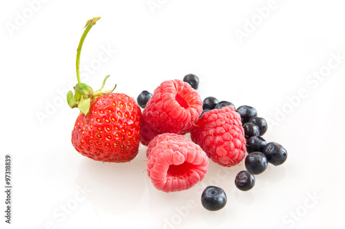Beautiful raspberry  strawberries and blueberries isolated on wh
