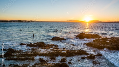 Fotografie, Tablou Surfer on waves in the sunset at byron bay