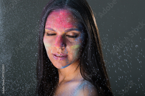 Beautiful young latin girl with colored powder on her face