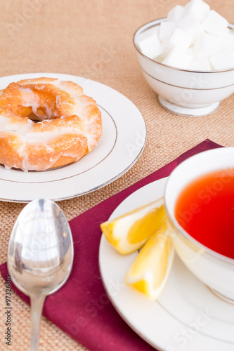 Breakfast with pastries, and hot tea with lemon.