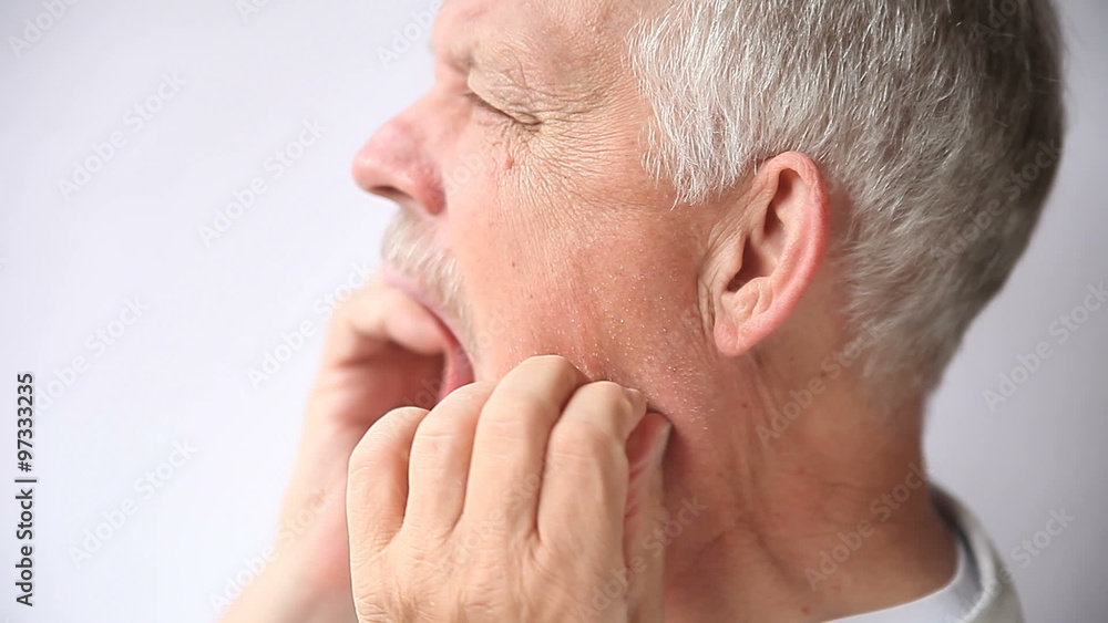 an older man experiencing pain either in his teeth or jaw joint
an older man experiencing pain either in his teeth or jaw joint