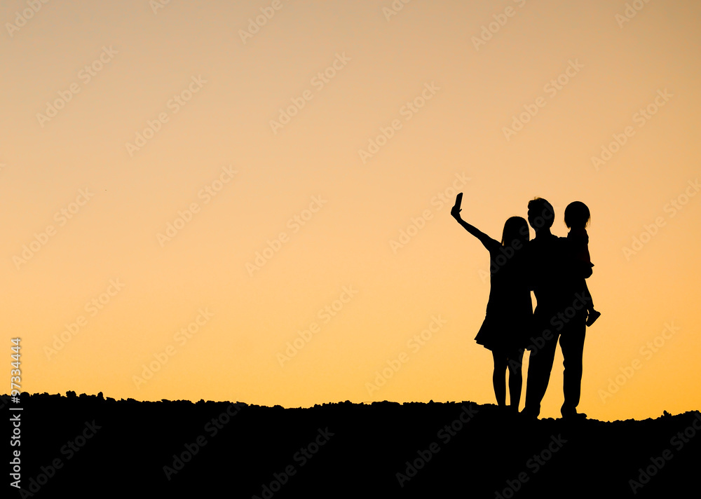 People in a family doing selfie silhouette