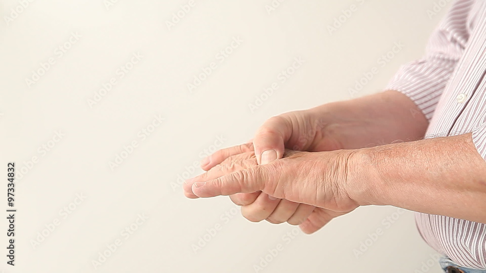 A man flexes and checks the joints in both hands. A man flexes and checks the joints in both hands.
