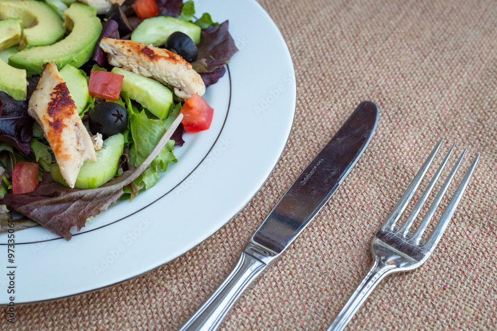 Chicken salad with avocado, mixed greens, cucumbers, tomatoes, and olives. Chicken salad with avocado, mixed greens, cucumbers, tomatoes, and olives.