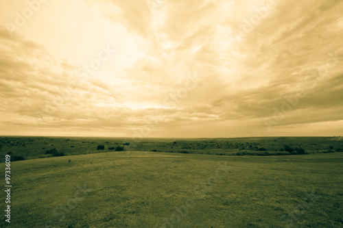 Wide Texas landscape and cloudy sky old-fashioned split toned effect.