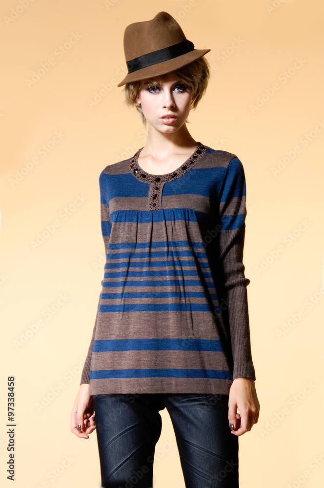 Portrait of young girl with hat posing on beige background Fashion photo Portrait of young girl with hat posing on beige background Fashion photo