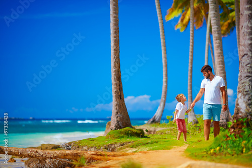 happy father and son walking on the paradise island