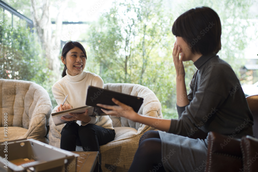 Two women have a meeting in a cafe Two women have a meeting in a cafe