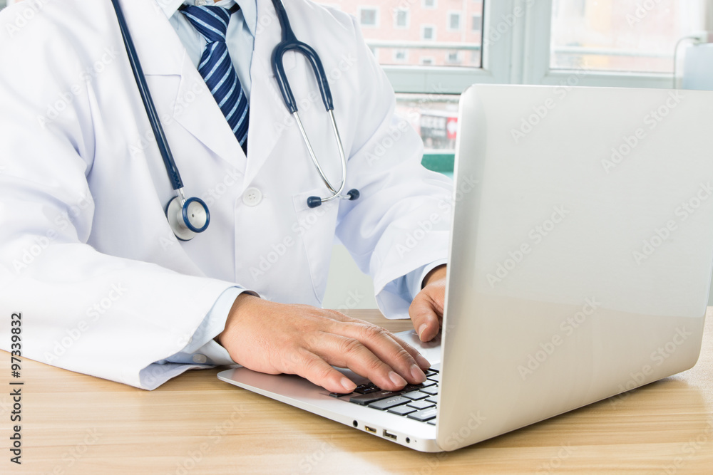 Doctors using laptop at work Doctors using laptop at work