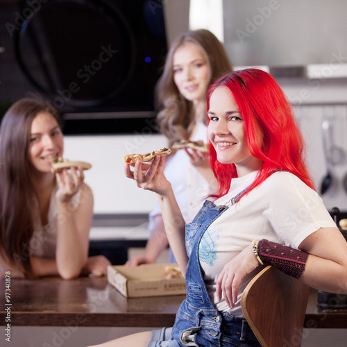 Group of young women in a kitchen room preparing food, friends