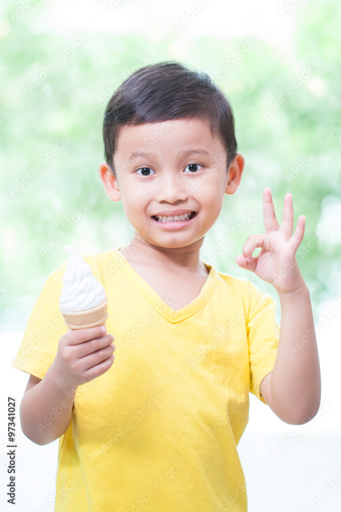 Happy asian boy eating ice-cream and showing ok sign. Happy asian boy eating ice-cream and showing ok sign.