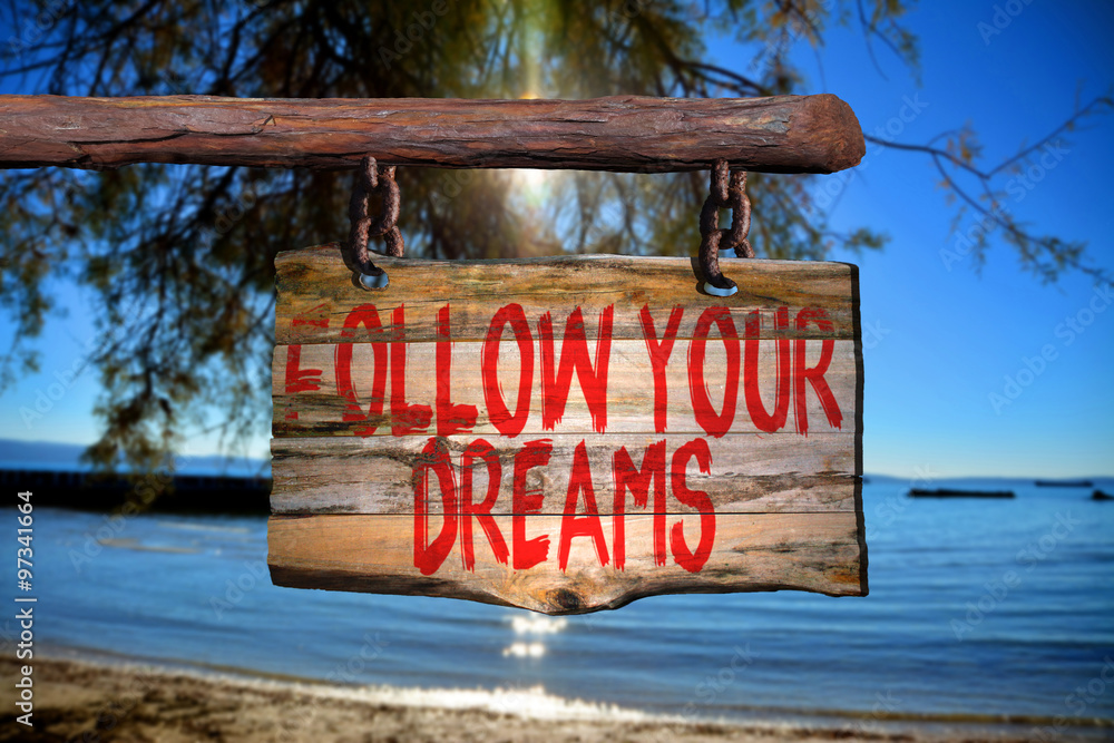 Fototapeta premium Follow your dreams motivational phrase sign