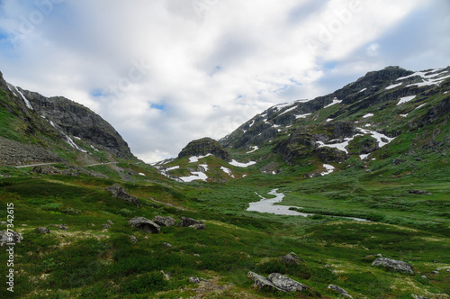 Picturesque valley between snowy rocks