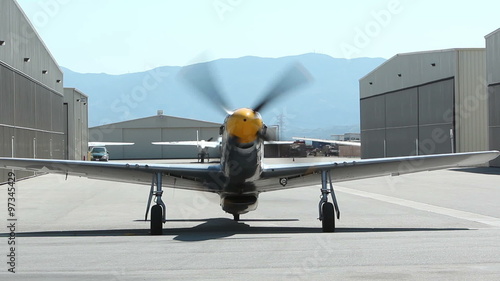 A World War II vintage North American P-51 Mustang fighter starts its engines