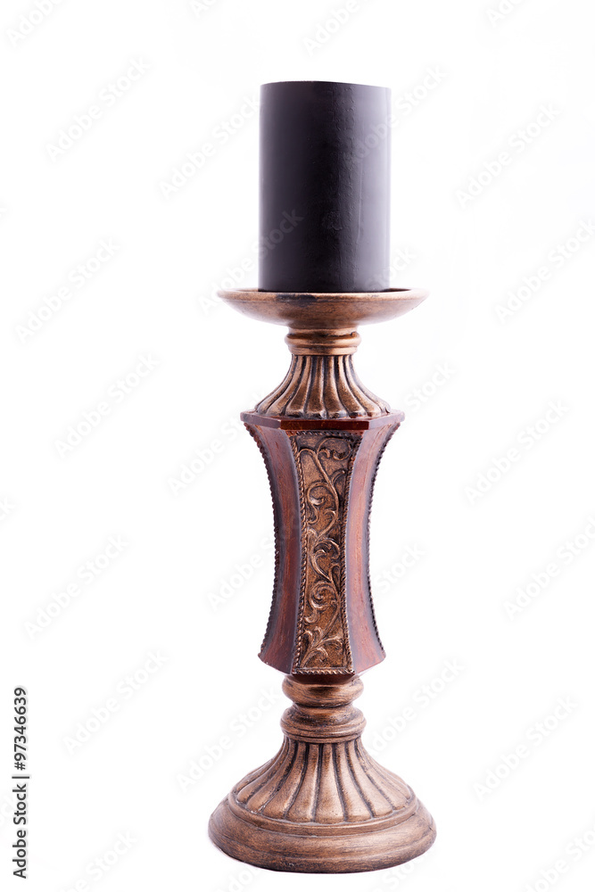 Old style candle holder with black candle in it Old style candle holder with black candle in it