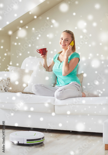 happy woman with smartphone drinking tea at home