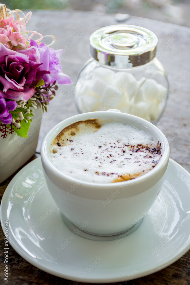 Hot cappuccino coffee with foam on top on wood table. Hot cappuccino coffee with foam on top on wood table.