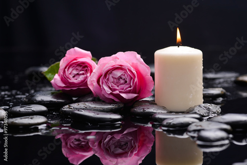 Pink rose with candle and therapy stones 