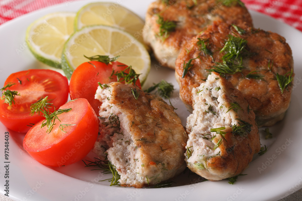 Tasty fried fish cake with herbs close-up on a plate. horizontal
Tasty fried fish cake with herbs close-up on a plate. horizontal