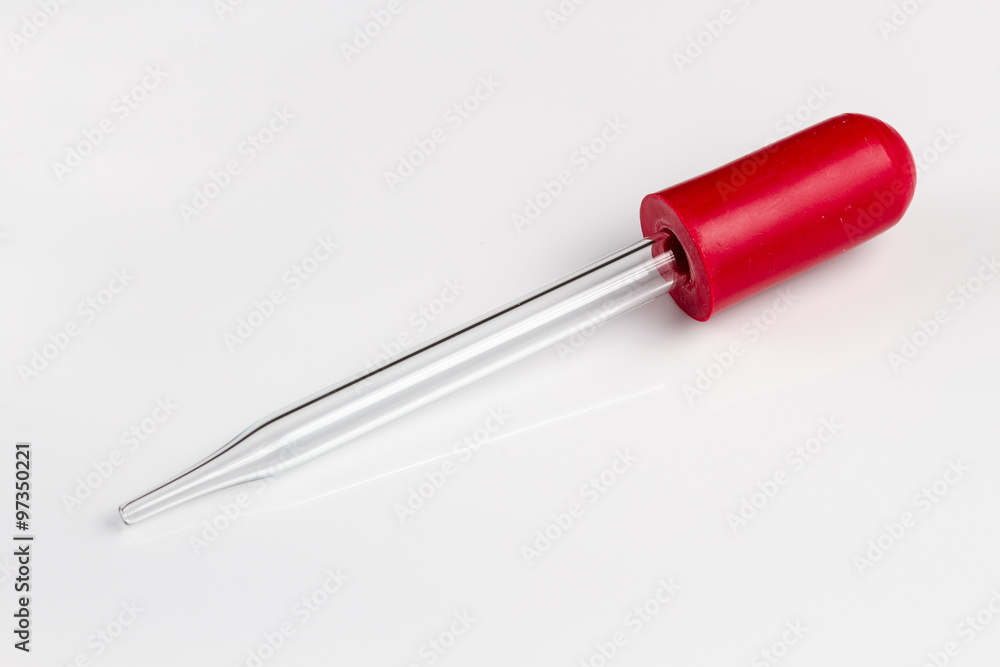 closeup of glass dropper with red rubber top closeup of glass dropper with red rubber top