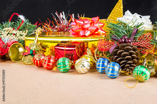 Fototapeta Naklejka Na Ścianę i Meble -  Christmas decorations, gifts, color balls, ribbons on a Veneer wood background.