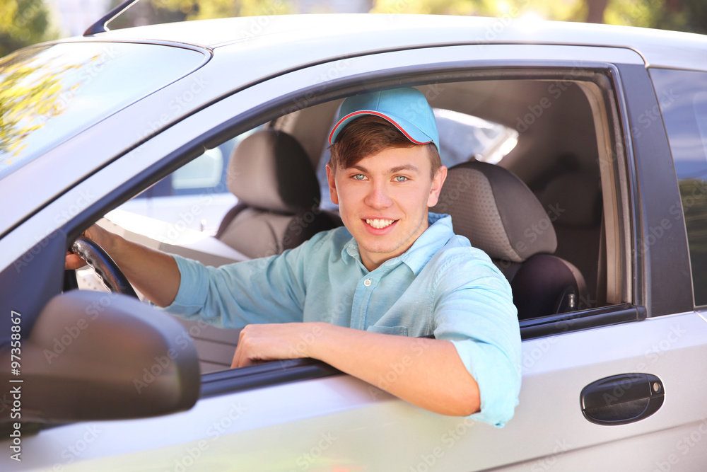 Pizza delivery boy with tablet in car, close-up Pizza delivery boy with tablet in car, close-up
