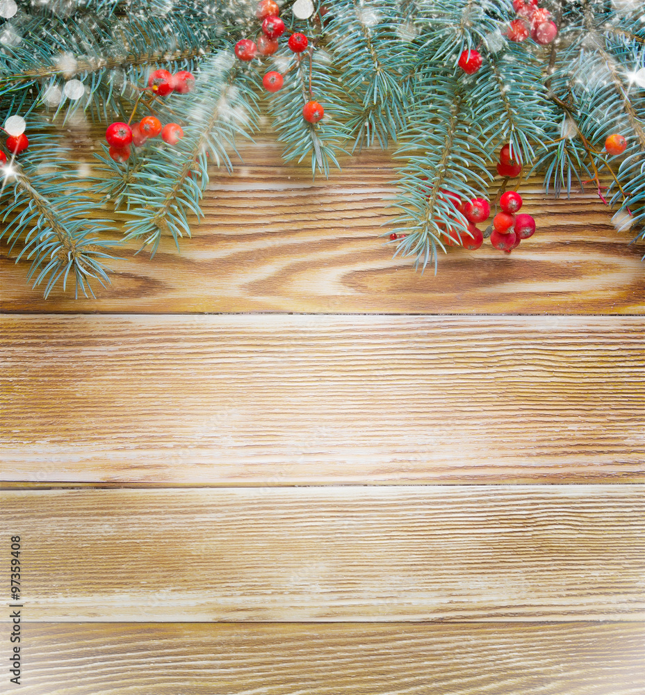 Fir branch with rowan on wooden background.Christmas frame wallpaper.