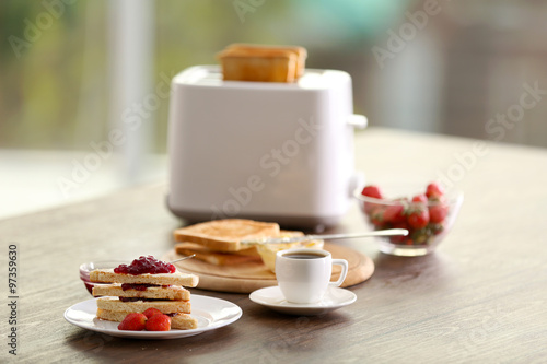Served table for breakfast with toast and jam  on blurred background