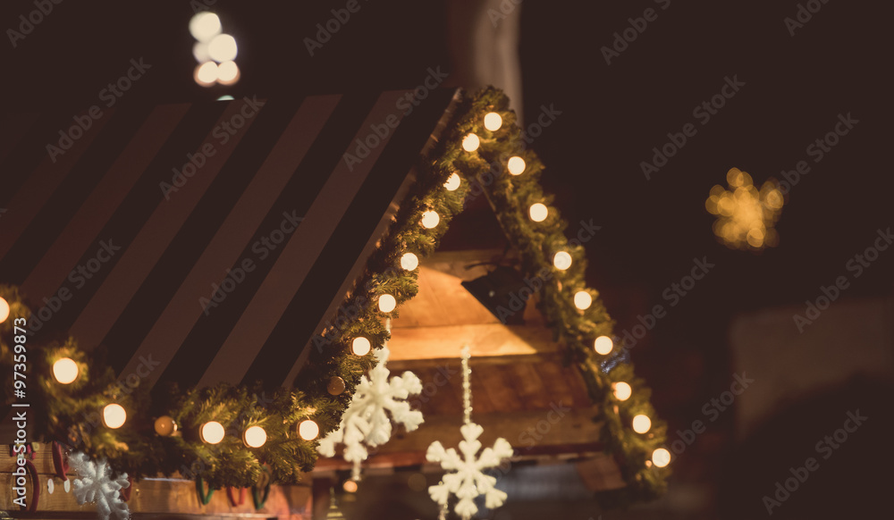 Fototapeta premium Wood house with Christmas decoration in a Christmas Market