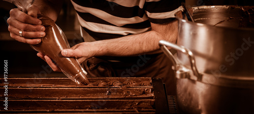 Pastry in his workshop preparing Chocolate Yule logs
