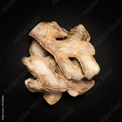 Top view of a Dried Ginger root or Sonth (Zingiber officinale) isolated on dark background. photo