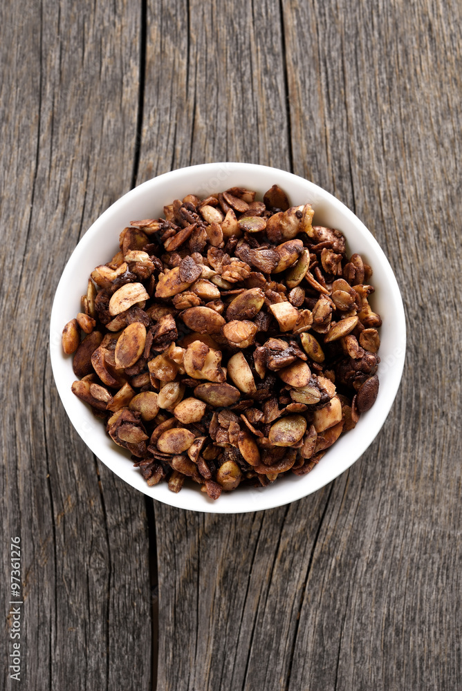 Chocolate granola in bow, top view Chocolate granola in bow, top view