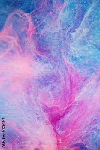 Blue pink clouds of ink in liquid