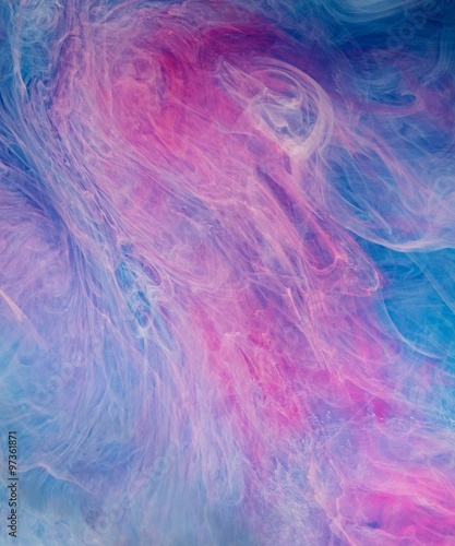 Blue pink clouds of ink in liquid