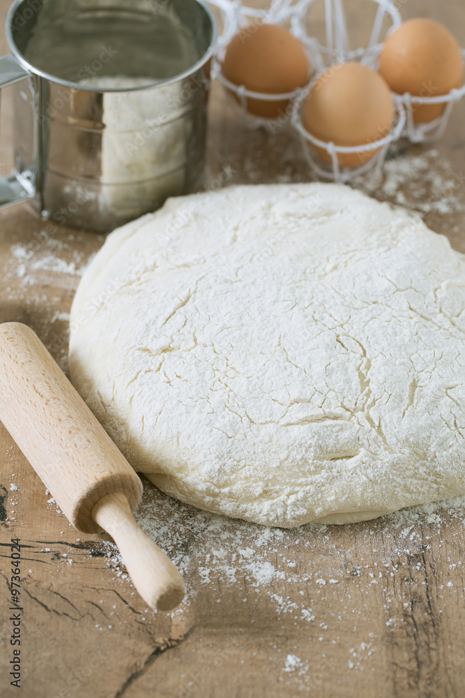 wooden rolling pin with freshly prepared dough wooden rolling pin with freshly prepared dough