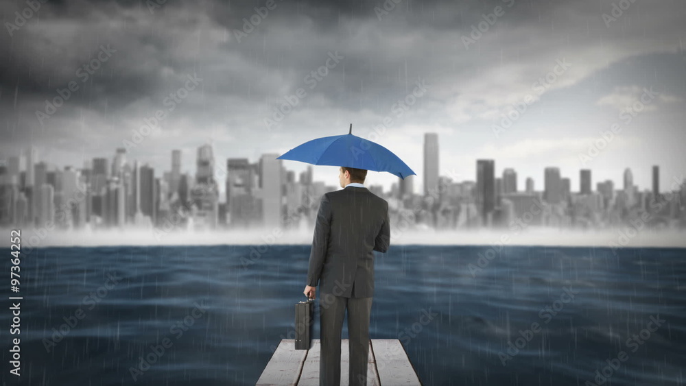 Composite image of businessman holding an umbrella Composite image of businessman holding an umbrella
