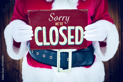 Фотография Composite image of mid section of santa claus holding page