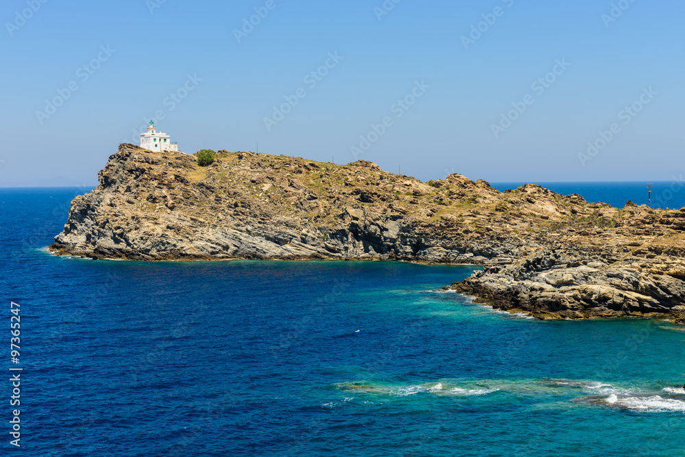 Lighthouse on a rocky coast, Paros island, Cyclades, Greece.