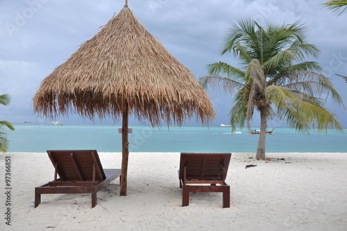 Tropical beach with chairs and umbrellas