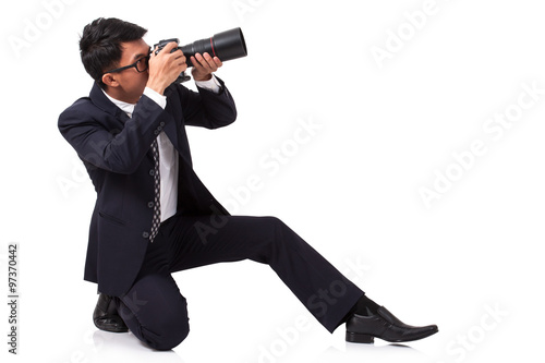 Obraz na płótnie Businessman taking a photo on white background w salonie