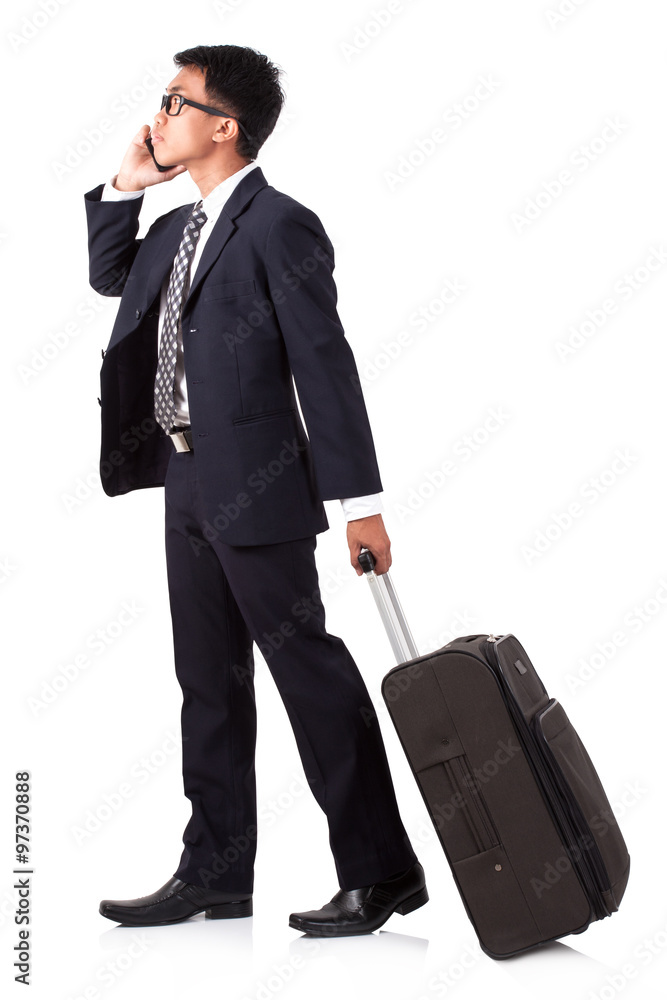 Businessman walking with suitcase and using smartphone on a white background Businessman walking with suitcase and using smartphone on a white background