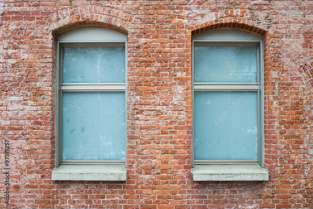 brick wall with two windows