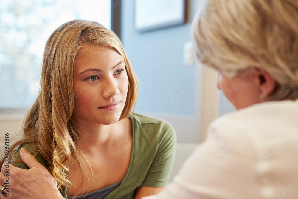 Doctor Treating Teenage Girl Suffering With Depression Doctor Treating Teenage Girl Suffering With Depression