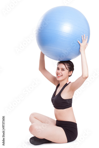 Young woman doing exercises with fitness ball.