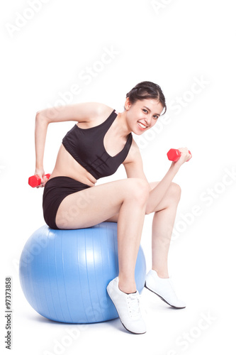 Fitness woman sport training with exercise ball and lifting weights
