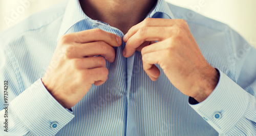 close up of man in shirt dressing  photo