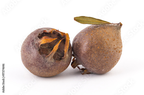 Fotografía Two fresh organic medlars, isolated on white background