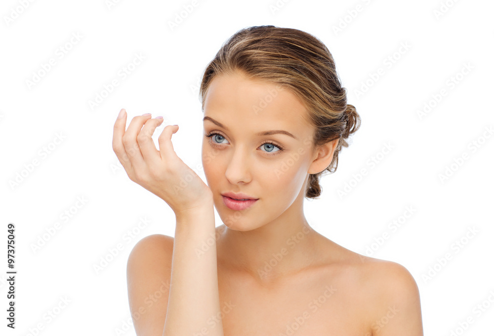 woman smelling perfume from wrist of her hand woman smelling perfume from wrist of her hand
